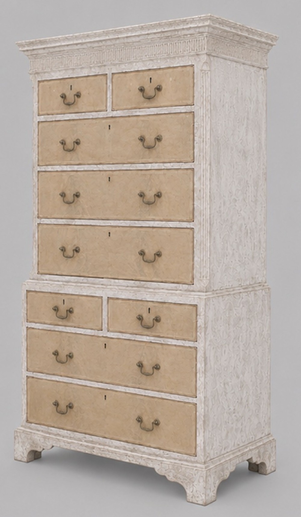 A George III chest on chest featuring a painted off-white frame, light tan drawer fronts, brass drop handles, and bracket feet. View III