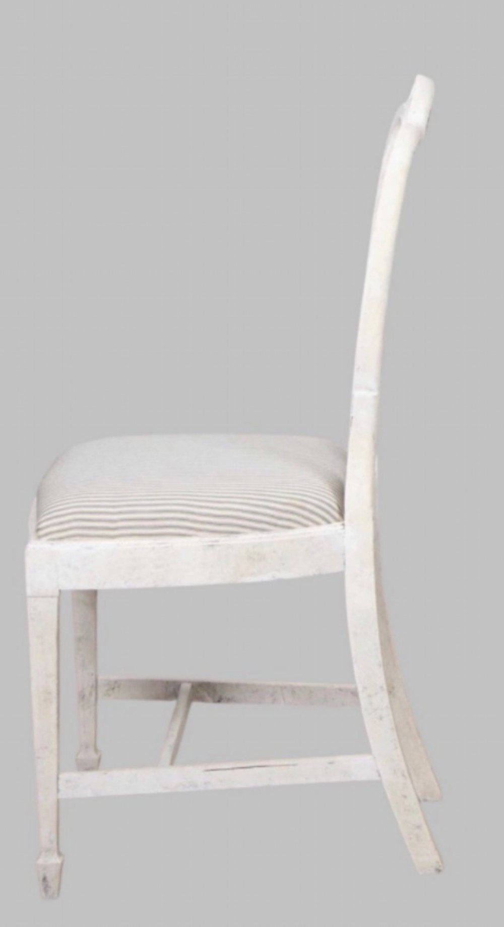 A set of eight off-white painted dining chairs featuring interlocking oval backrests, striped upholstered seats, including two carver armchairs and six side chairs. View V