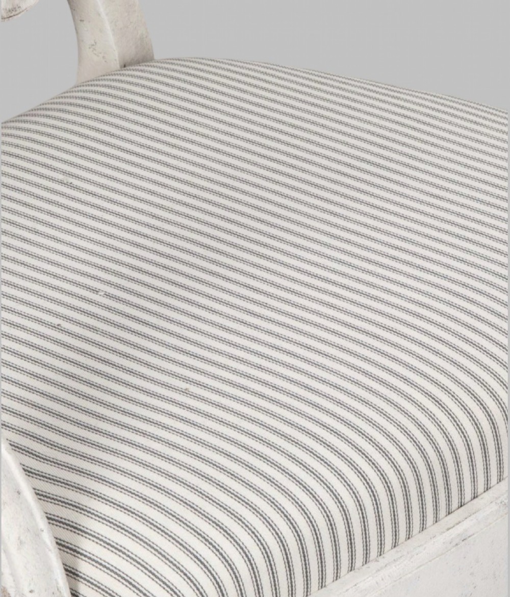 A set of eight off-white painted dining chairs featuring interlocking oval backrests, striped upholstered seats, including two carver armchairs and six side chairs. View VI