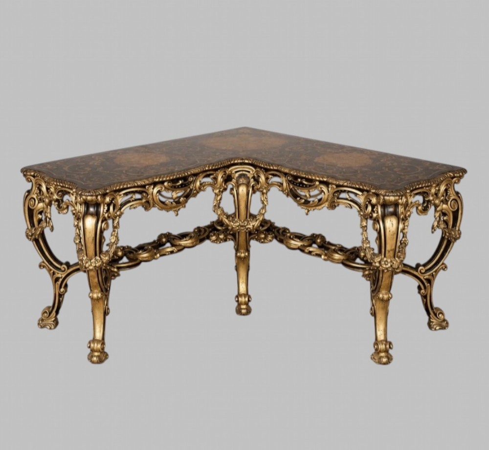 An L-shaped 19th-century Italian corner console table with elaborate gilded carvings, cabriole legs, and a detailed patterned top.