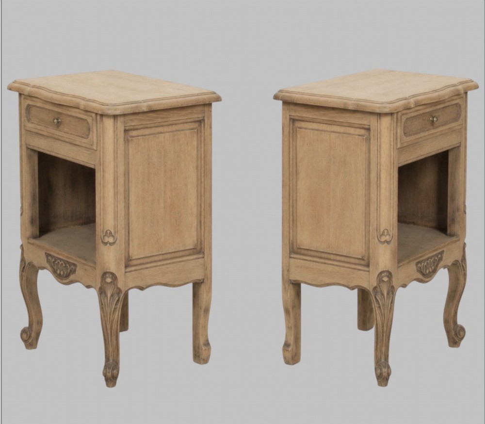 A pair of antique bleached oak bedside tables featuring carved cabriole legs, open storage shelves, and single top drawers with brass knobs. View II