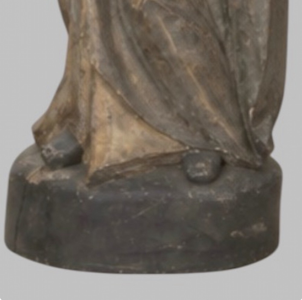 A carved wooden statue depicting the Virgin Mary holding the Infant Jesus on an integrated round base. View V