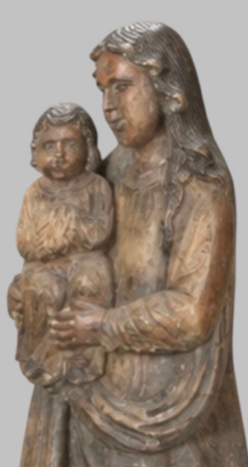 A carved wooden statue depicting the Virgin Mary holding the Infant Jesus on an integrated round base. View VI