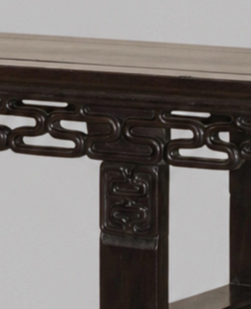 A late 19th-century Chinese dark hardwood altar table with an openwork geometric carved apron and recessed leg stretchers. View IV