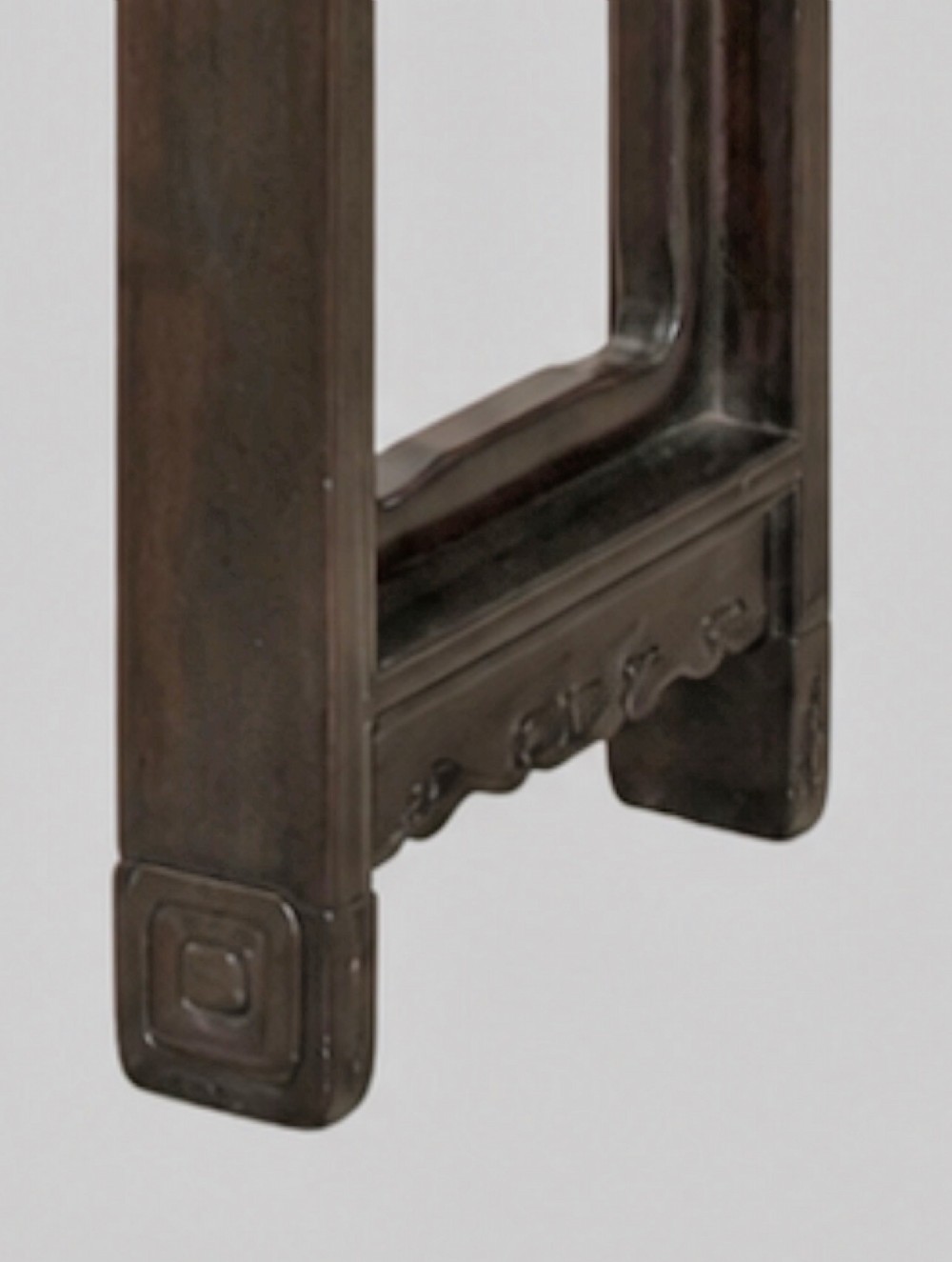 A late 19th-century Chinese dark hardwood altar table with an openwork geometric carved apron and recessed leg stretchers. View V