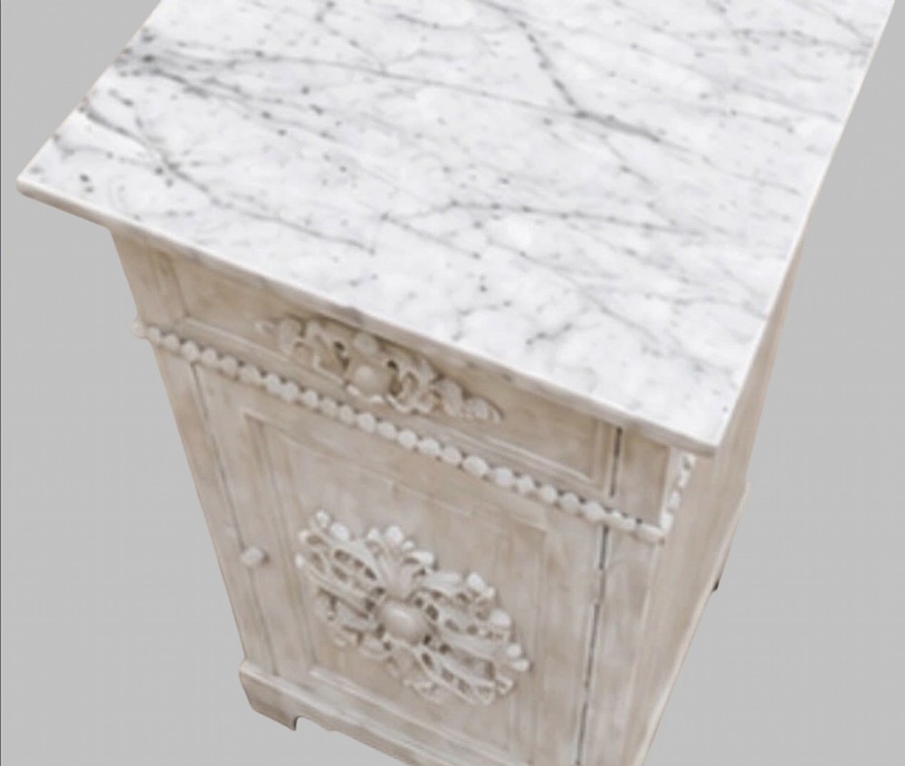 A pair of French off-white painted bedside cabinets featuring fitted marble tops, single drawers, and cupboard doors with central carved foliate relief motifs. View III