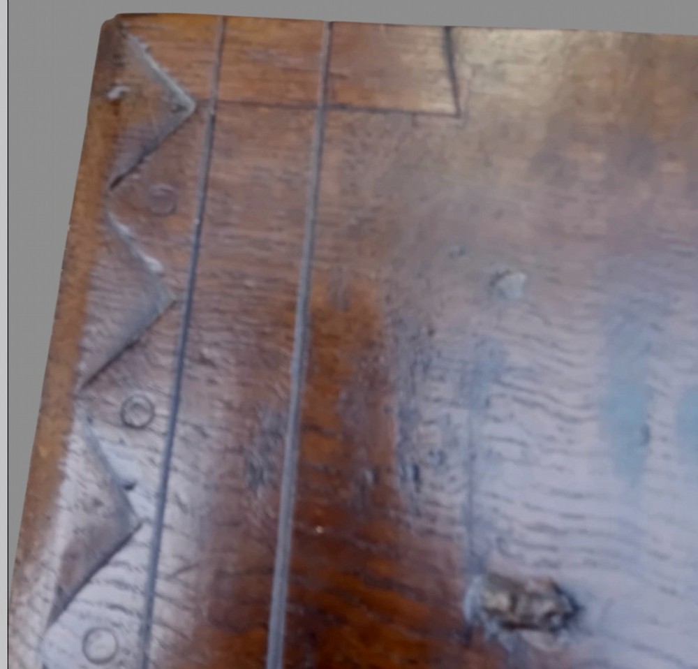 A dark oak hall table featuring turned legs, lower perimeter stretchers, a carved scrollwork frieze, and a carved central medallion on the top surface. View VII