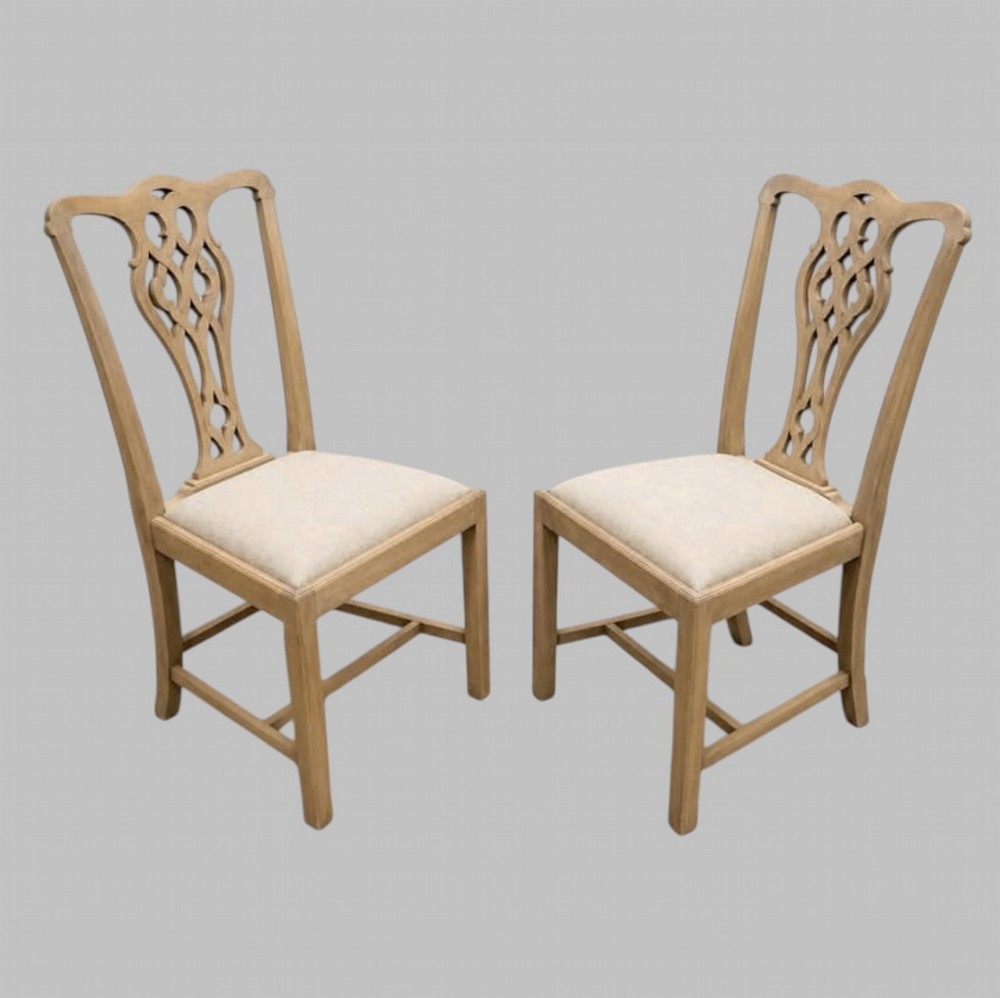 A set of eight mid-19th century bleached mahogany dining chairs featuring pierced fretwork splats and neutral fabric upholstered seats. View II