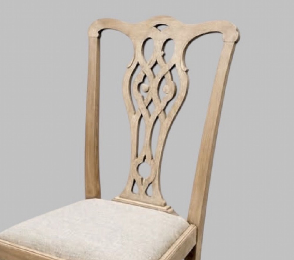 A set of eight mid-19th century bleached mahogany dining chairs featuring pierced fretwork splats and neutral fabric upholstered seats. View VI