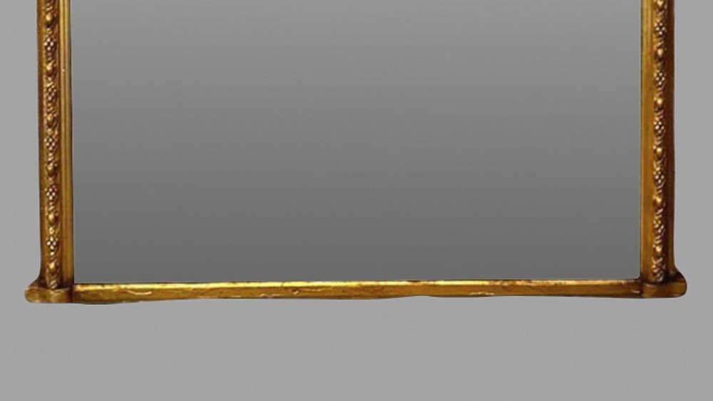 A large nineteenth-century giltwood pier mirror with an arched upper frame and beaded moulding detail. View III