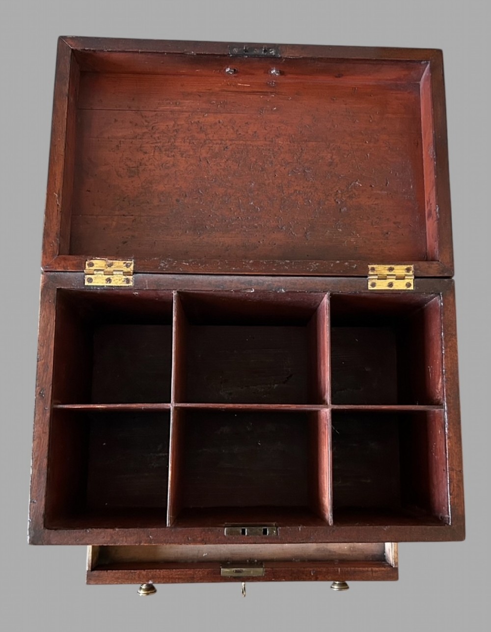 A Georgian mahogany wine cellarette featuring a hinged lid with a top brass handle, keyhole, lower drawer, and four turned legs. View III