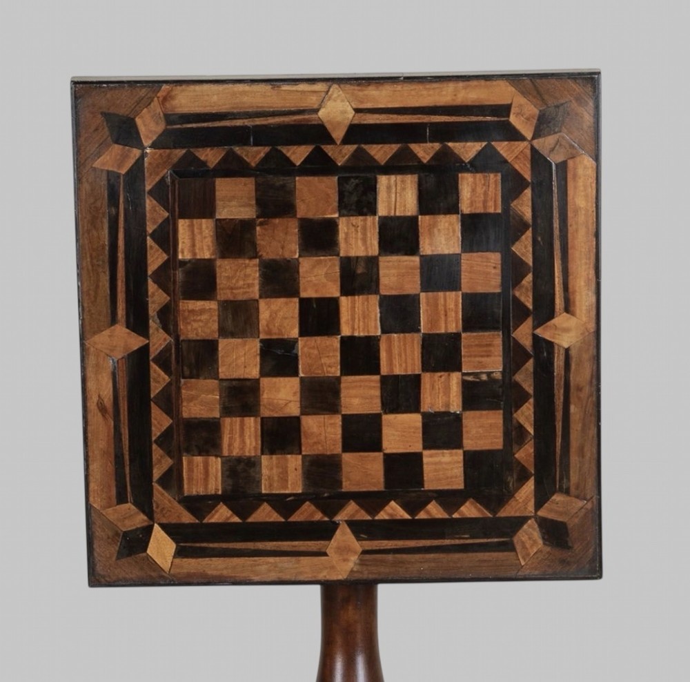 A Georgian tilt-top games table with a square geometric inlaid chessboard top mounted on a turned pedestal column and triform base with ball feet. View III