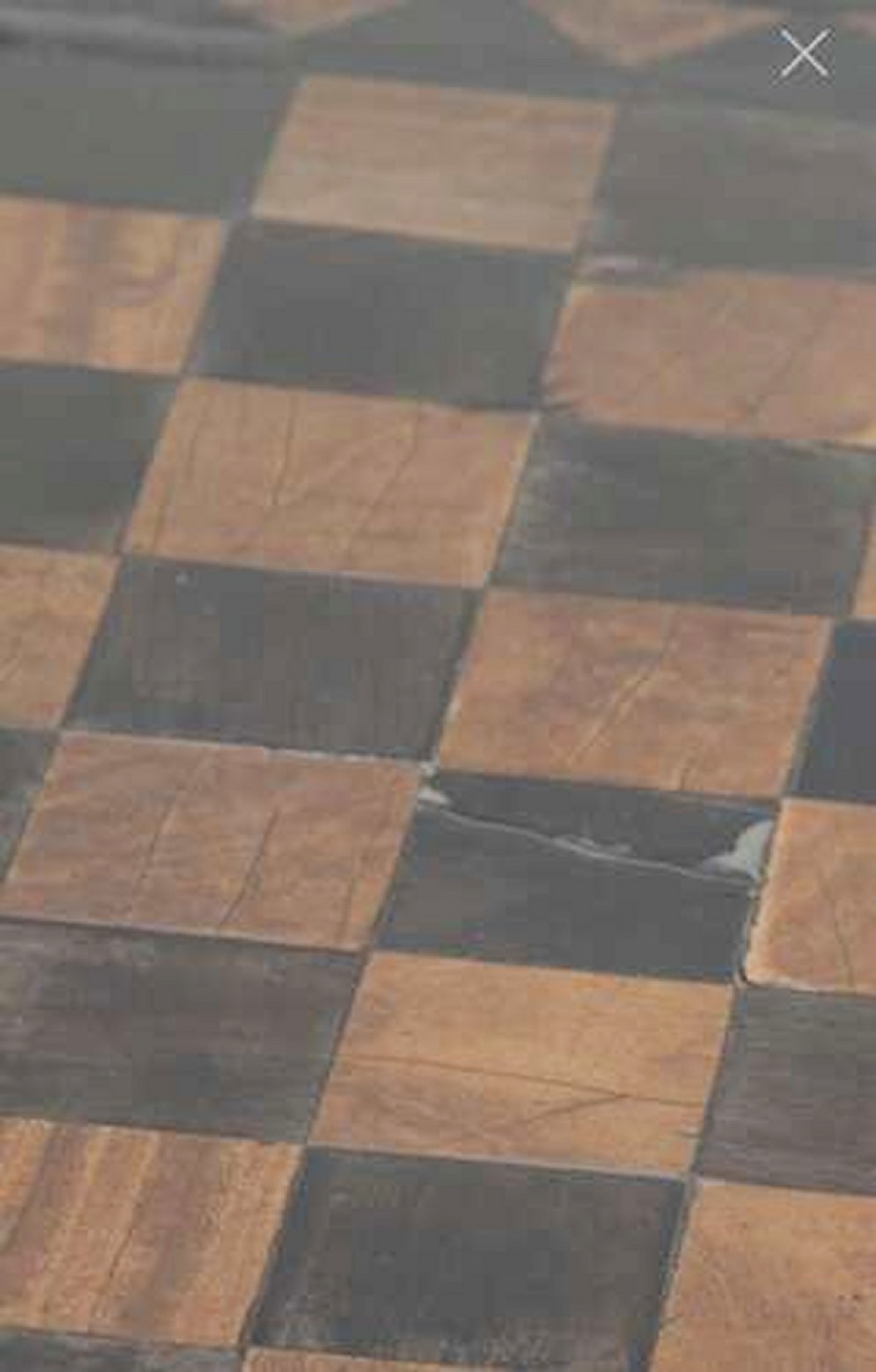 A Georgian tilt-top games table with a square geometric inlaid chessboard top mounted on a turned pedestal column and triform base with ball feet. View V
