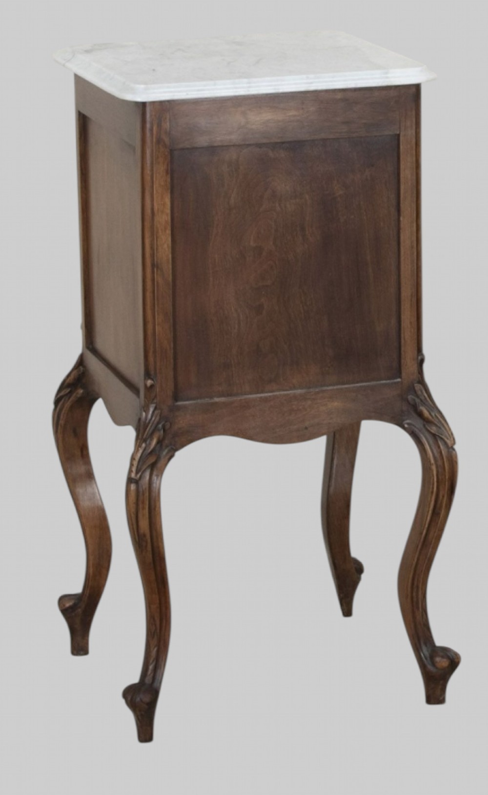 A pair of French walnut bedside cabinets featuring white marble tops, single drawers over cupboard doors, carved aprons, and slender cabriole legs. View III