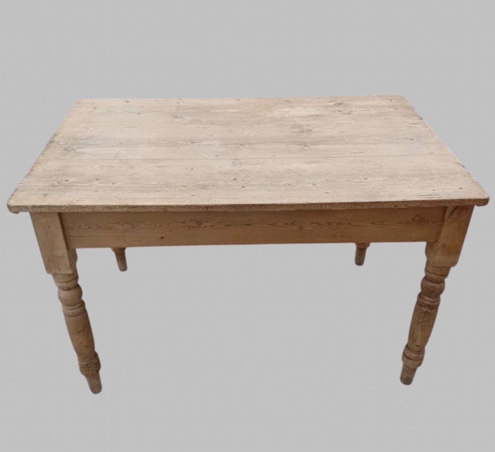 A late 19th-century rectangular pine farmhouse table featuring a scrubbed wood plank top, a frieze drawer with turned wooden knobs, and turned legs. View II