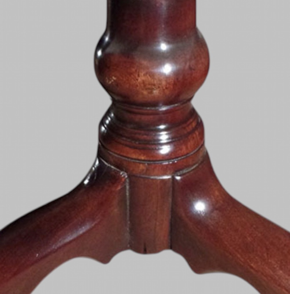 A Georgian mahogany tilt-top occasional table featuring a circular surface supported by a turned pedestal stem and tripod cabriole legs. View III