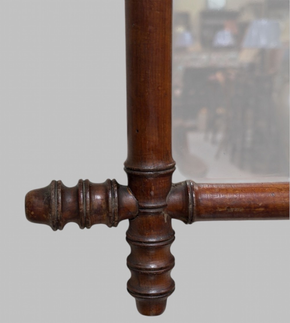An antique turned wood wall mirror styled with a faux bamboo frame finished in a warm brown stain. View V