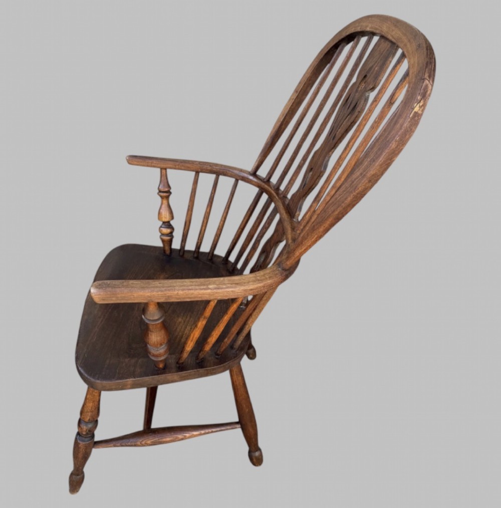 A nineteenth-century hoop-back Windsor armchair crafted from ash and elm wood, featuring a shaped saddle seat, pierced splat, slender back spindles, turned front legs, and an H-stretcher. View III