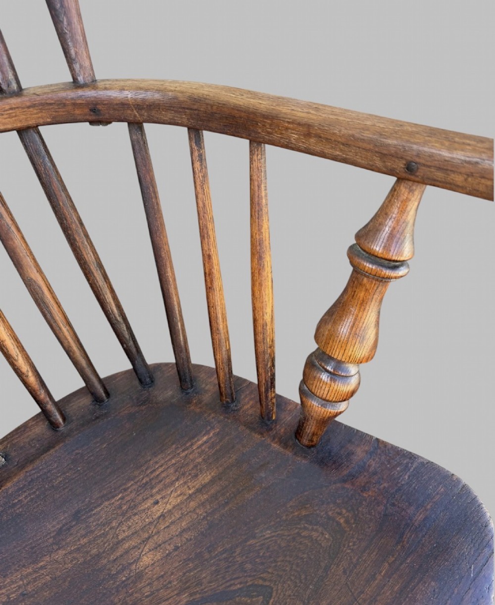 A nineteenth-century hoop-back Windsor armchair crafted from ash and elm wood, featuring a shaped saddle seat, pierced splat, slender back spindles, turned front legs, and an H-stretcher. View VI