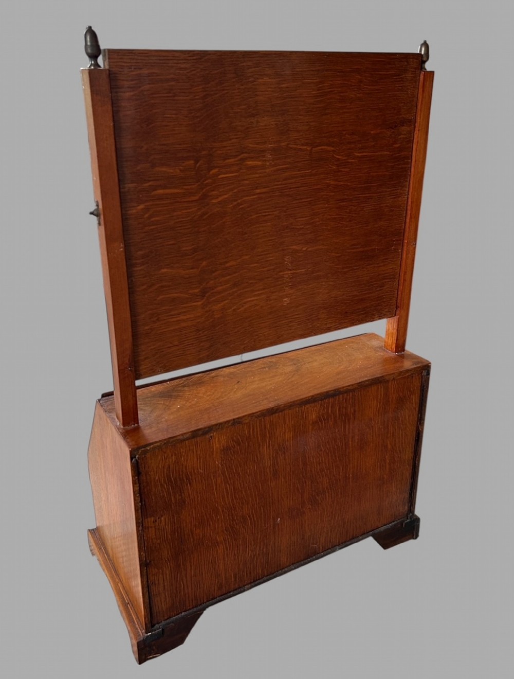 An Edwardian satinwood tabletop bureau featuring a slant-front writing slope over small drawers, topped with a rectangular swivel dressing mirror. View VI