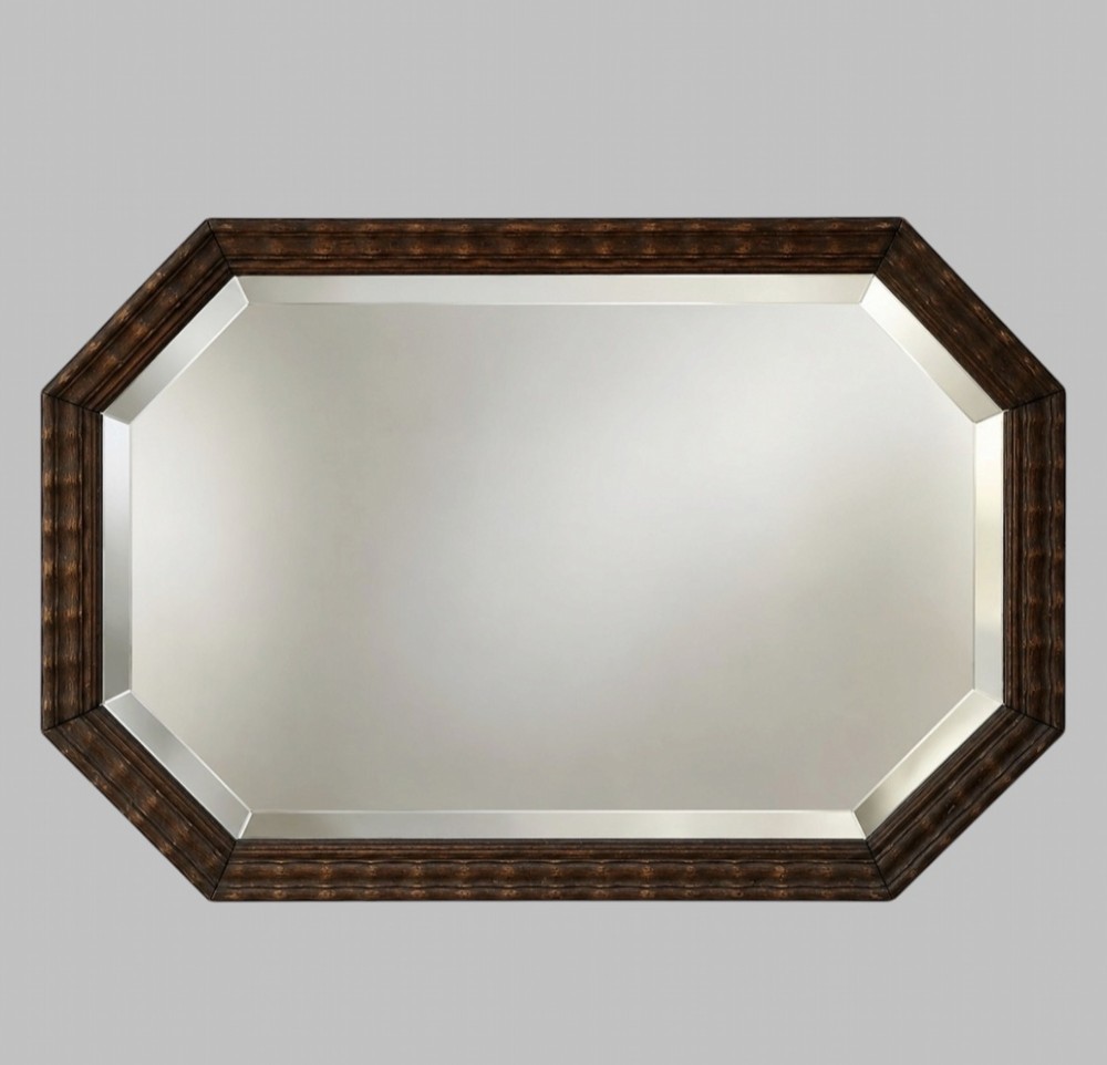 An octagonal early 20th-century wall mirror featuring a dark reeded wooden frame and a central bevelled glass plate.
