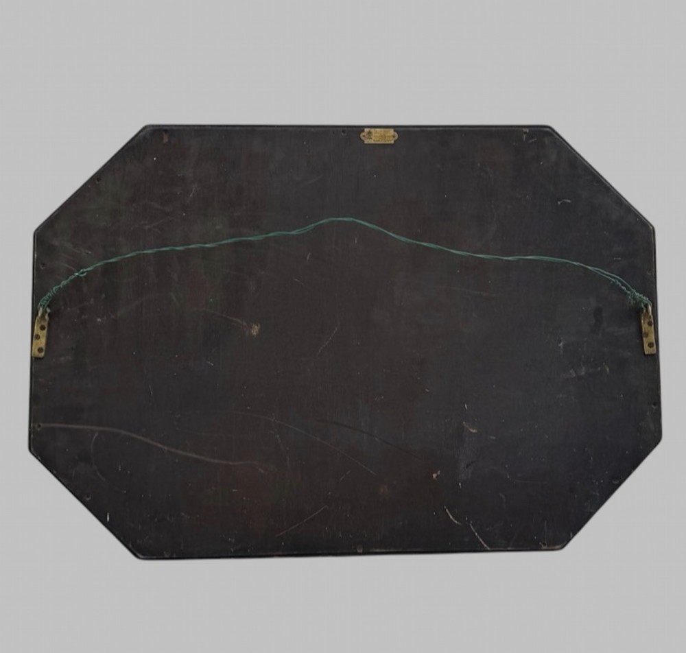 An octagonal early 20th-century wall mirror featuring a dark reeded wooden frame and a central bevelled glass plate. View V