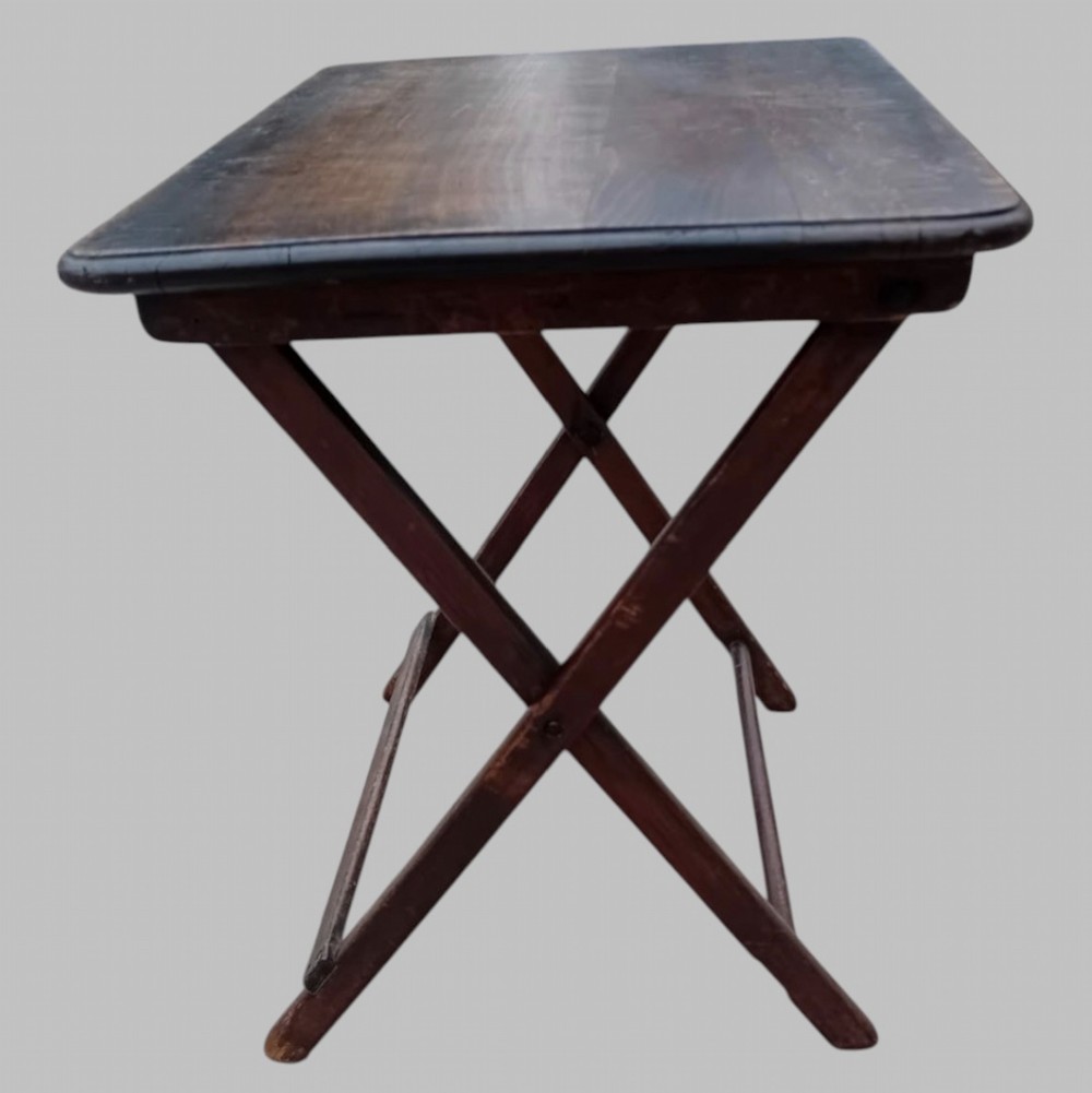 An early twentieth-century dark stained beech folding table featuring a rectangular top with rounded corners and collapsible wooden legs. View III