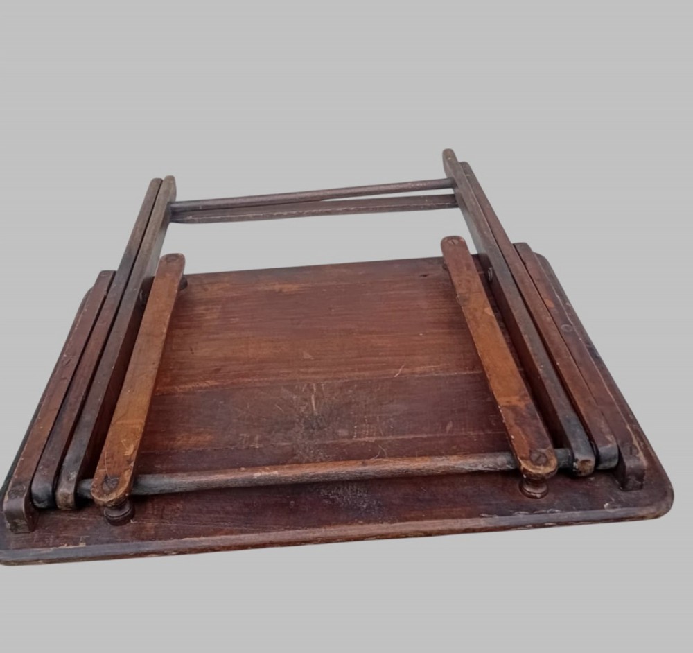 An early twentieth-century dark stained beech folding table featuring a rectangular top with rounded corners and collapsible wooden legs. View V