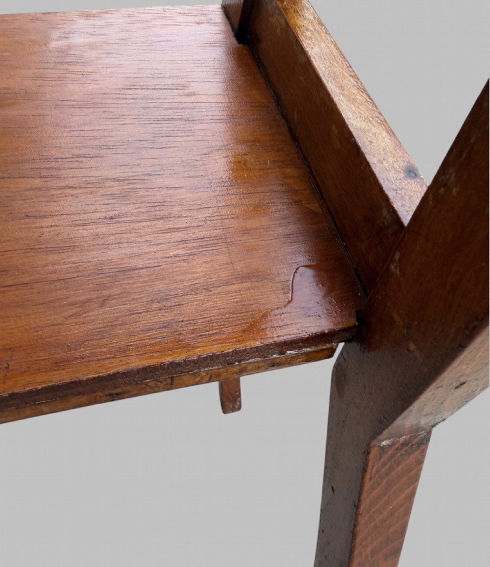An Arts and Crafts style warm brown oak metamorphic library chair featuring a pierced heart-shaped cutout on the top rail and a hinged seat mechanism. View VII