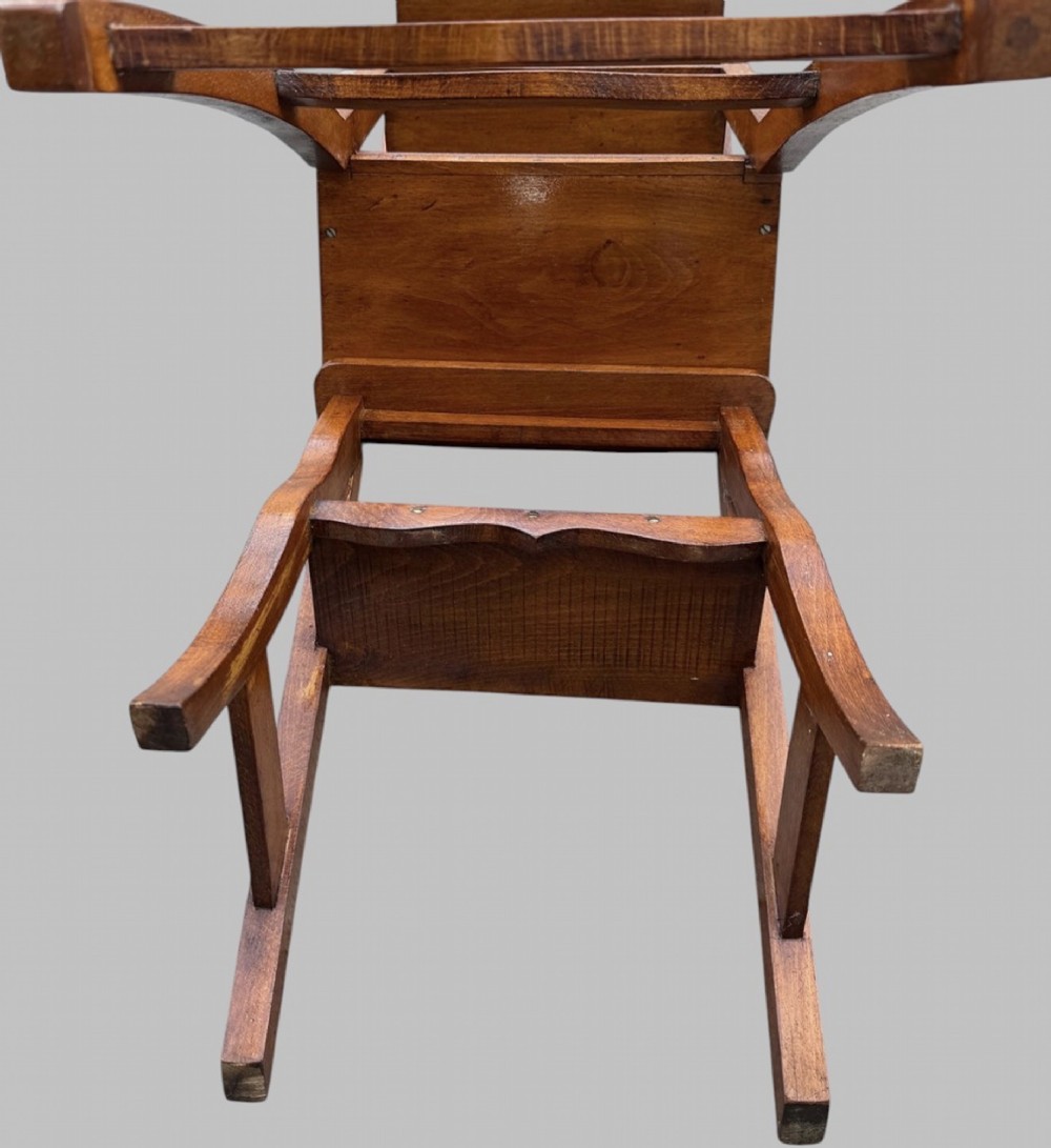 An Arts and Crafts style warm brown oak metamorphic library chair featuring a pierced heart-shaped cutout on the top rail and a hinged seat mechanism. View VIII