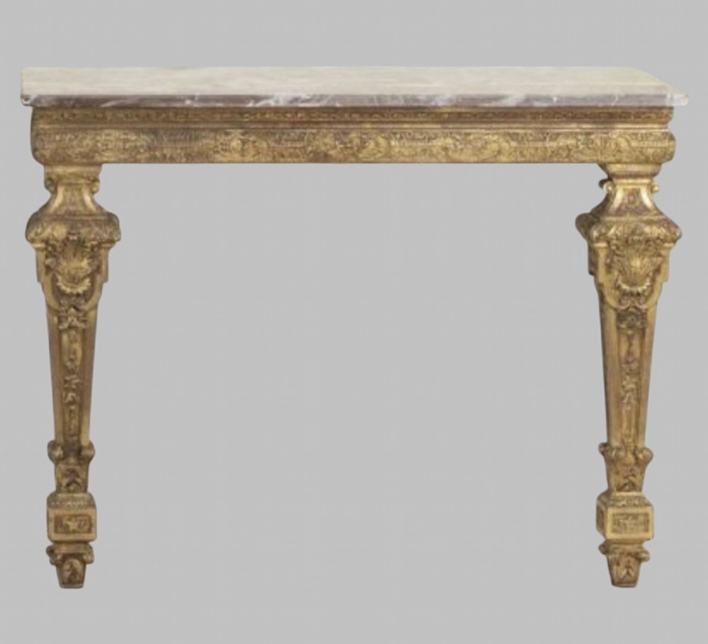 A pair of 19th-century Italian giltwood console tables featuring carved tapered legs and fitted marble tops. View II