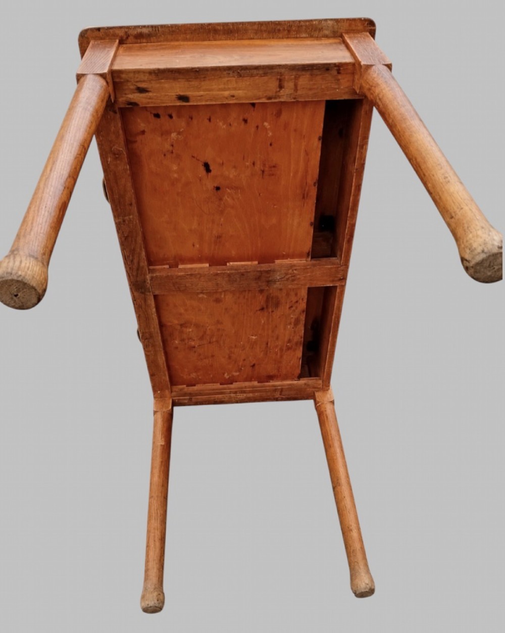 An early 20th-century light oak work table featuring a rectangular top, two frieze drawers with brass cup handles, and turned legs. View V