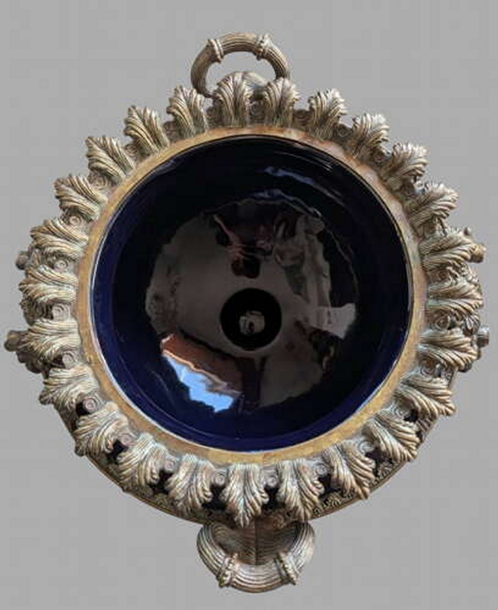 A pair of 19th-century dark blue ceramic jardinieres featuring ornate gilt metal mounts, dual scroll handles, and flared pedestal bases. View VII