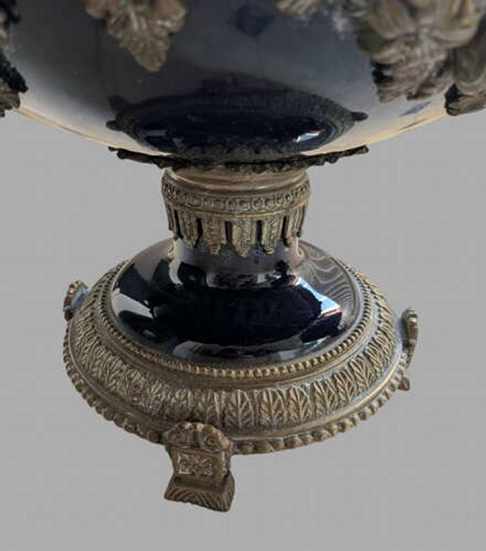 A pair of 19th-century dark blue ceramic jardinieres featuring ornate gilt metal mounts, dual scroll handles, and flared pedestal bases. View VIII