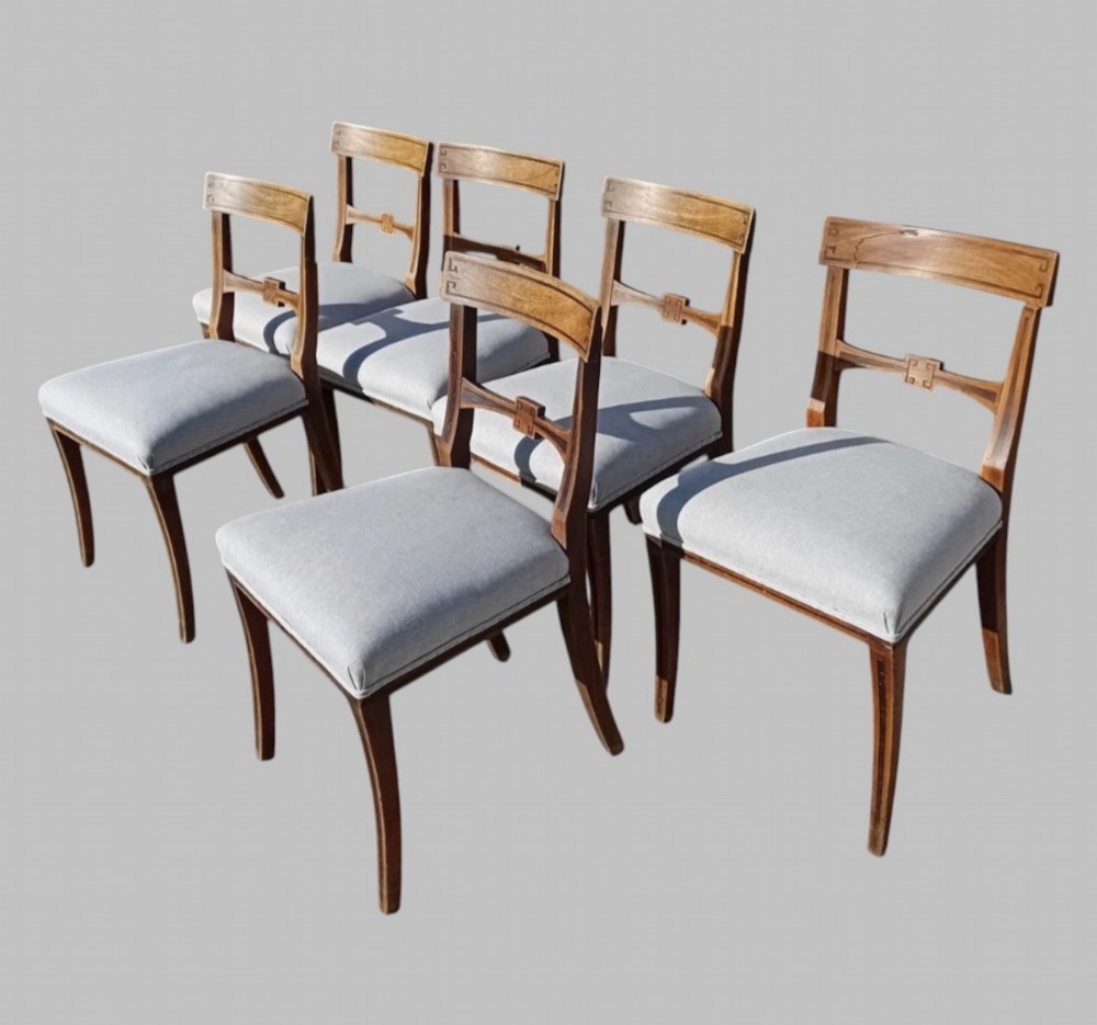 A set of six late 19th-century mahogany dining chairs with geometric marquetry inlay and light grey upholstered seats. View II