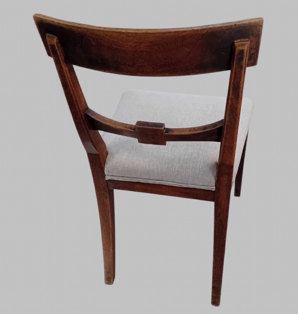 A set of six late 19th-century mahogany dining chairs with geometric marquetry inlay and light grey upholstered seats. View III