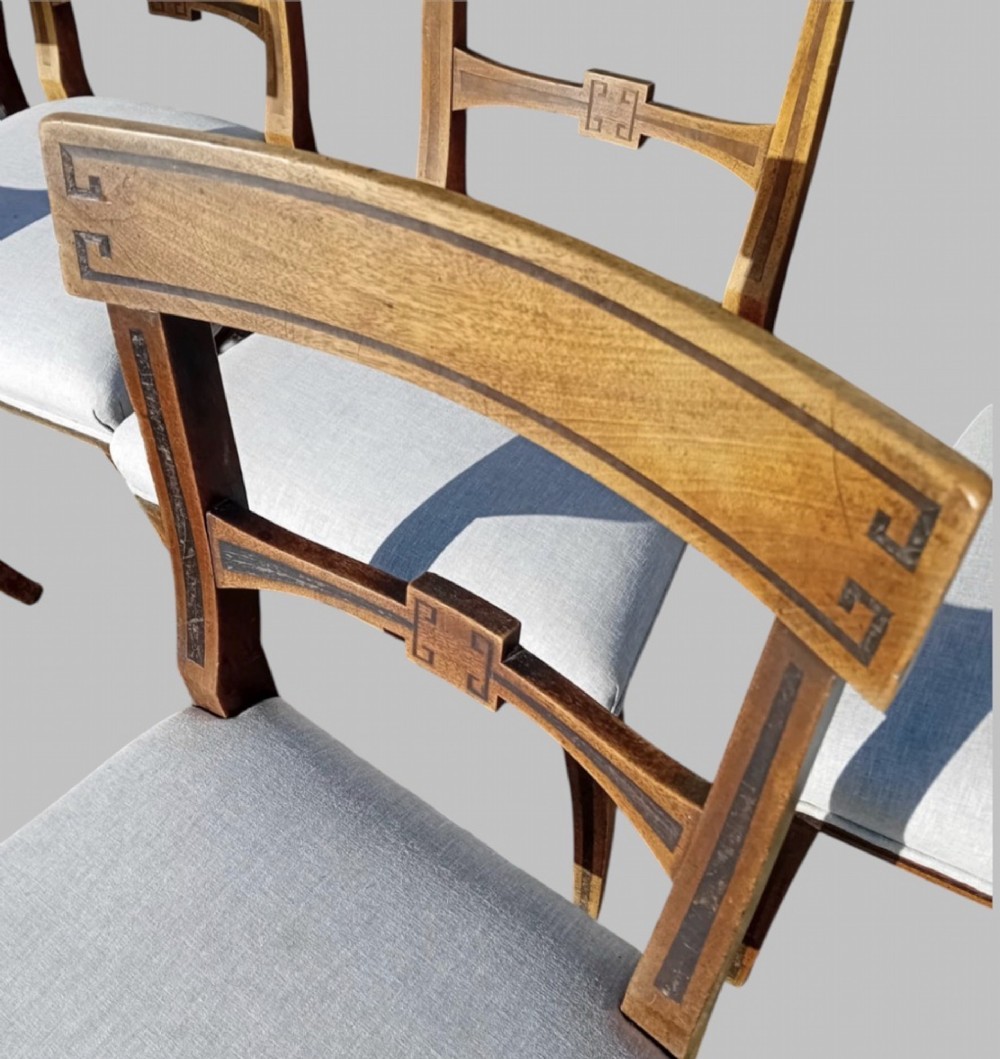 A set of six late 19th-century mahogany dining chairs with geometric marquetry inlay and light grey upholstered seats. View IV