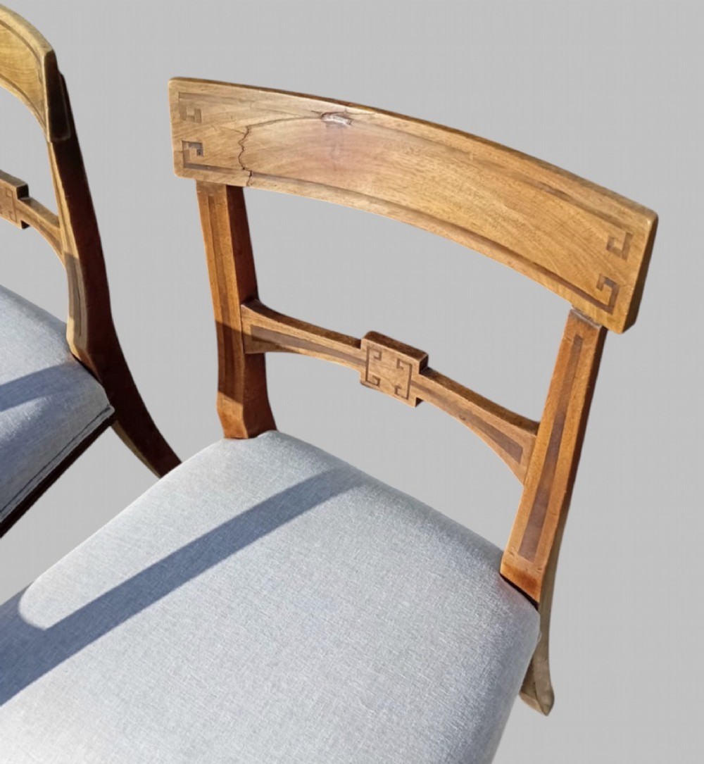 A set of six late 19th-century mahogany dining chairs with geometric marquetry inlay and light grey upholstered seats. View VII