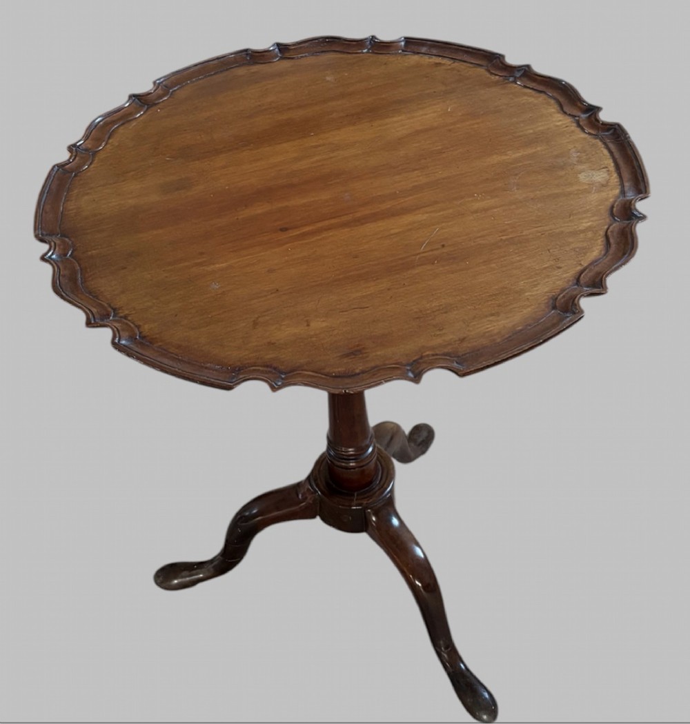 A dark mahogany tripod table featuring a circular pie-crust scalloped top, a turned central column with a birdcage block, and three cabriole legs ending in pad feet. View II