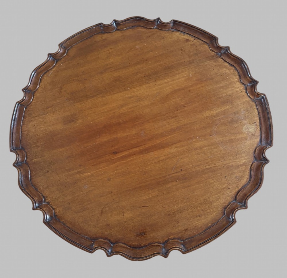 A dark mahogany tripod table featuring a circular pie-crust scalloped top, a turned central column with a birdcage block, and three cabriole legs ending in pad feet. View III