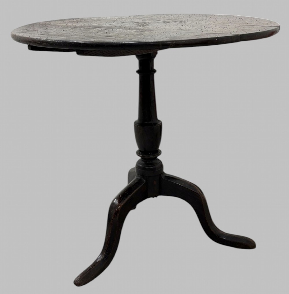 A 19th-century dark mahogany tilt-top table featuring a circular top, turned central column, and three splayed legs. View II