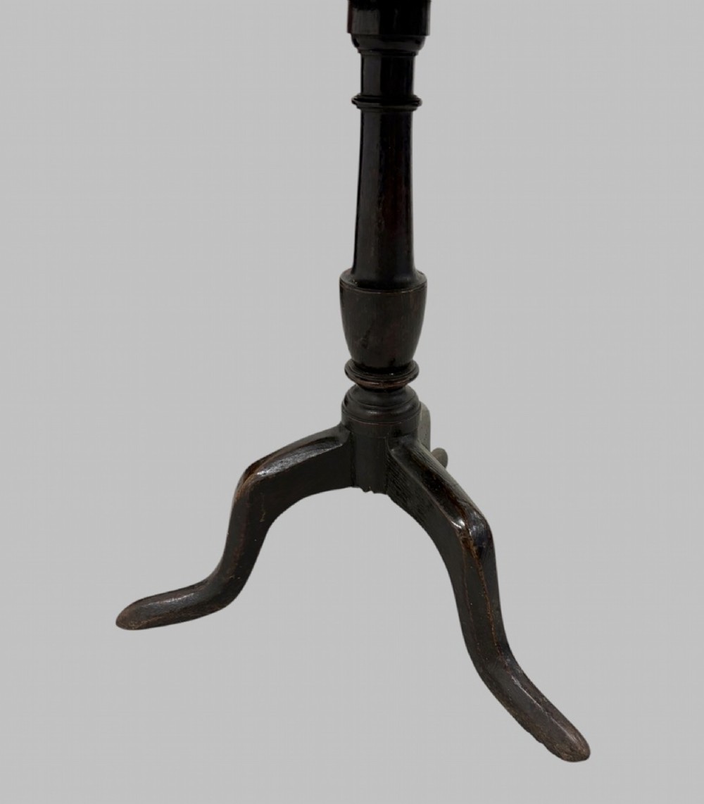 A 19th-century dark mahogany tilt-top table featuring a circular top, turned central column, and three splayed legs. View III