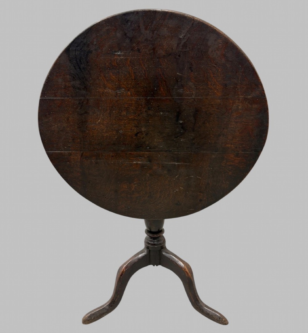 A 19th-century dark mahogany tilt-top table featuring a circular top, turned central column, and three splayed legs. View IV