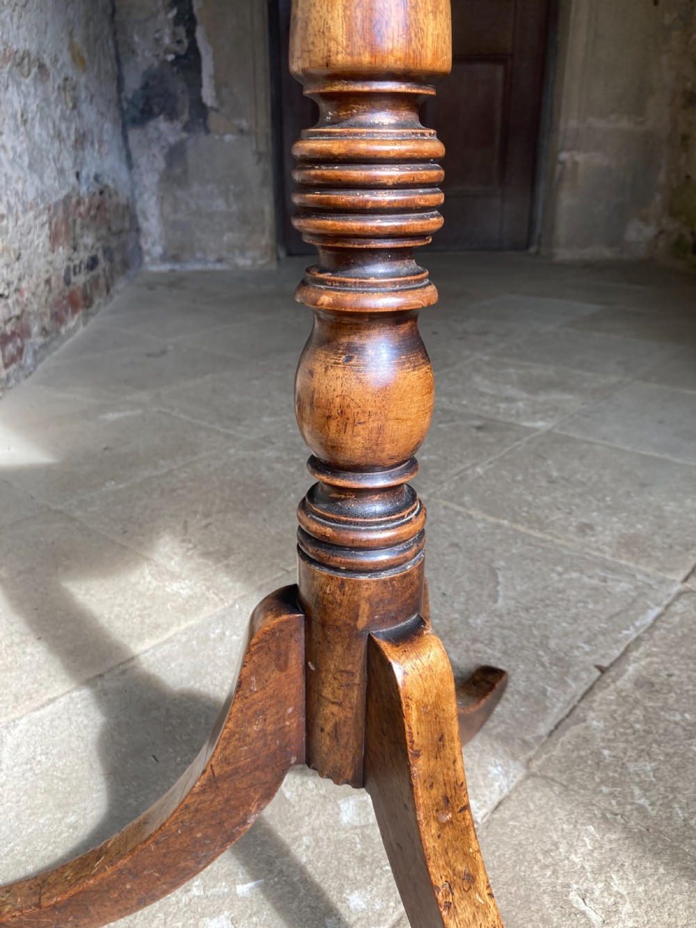 A Regency mahogany tripod table featuring a rectangular surface with rounded corners, a central turned stem, and three splayed legs. View V