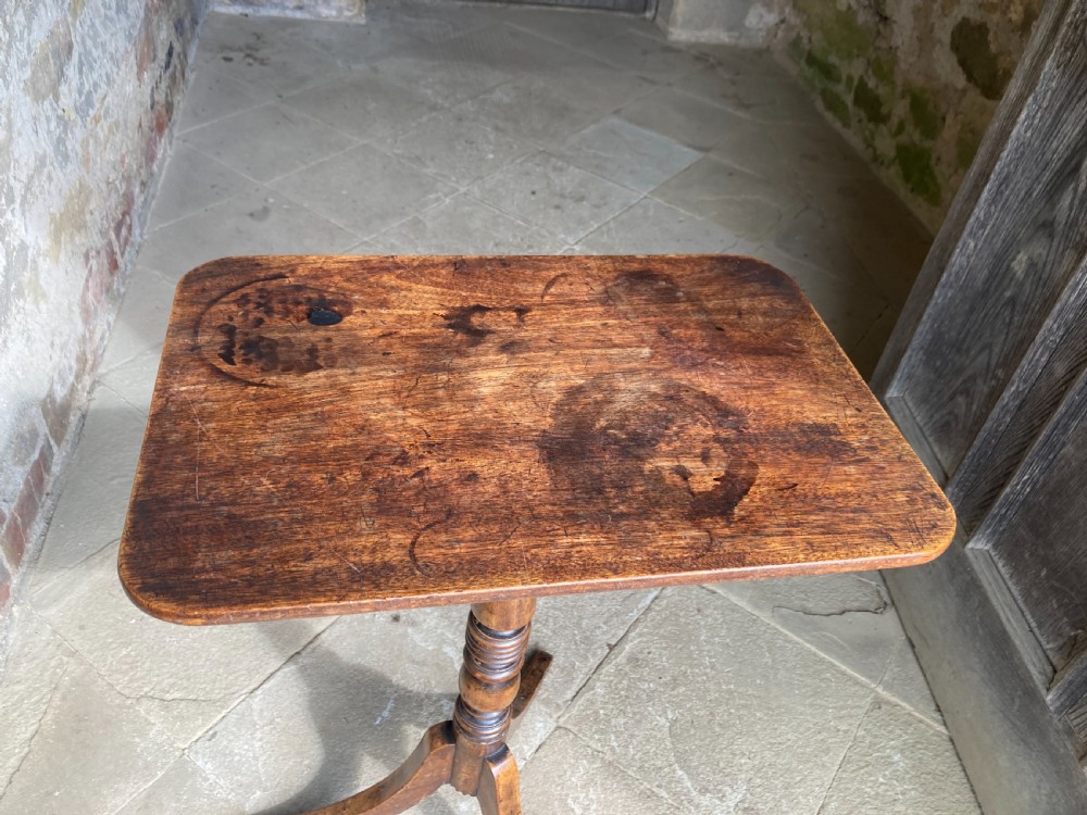 A Regency mahogany tripod table featuring a rectangular surface with rounded corners, a central turned stem, and three splayed legs. View VI