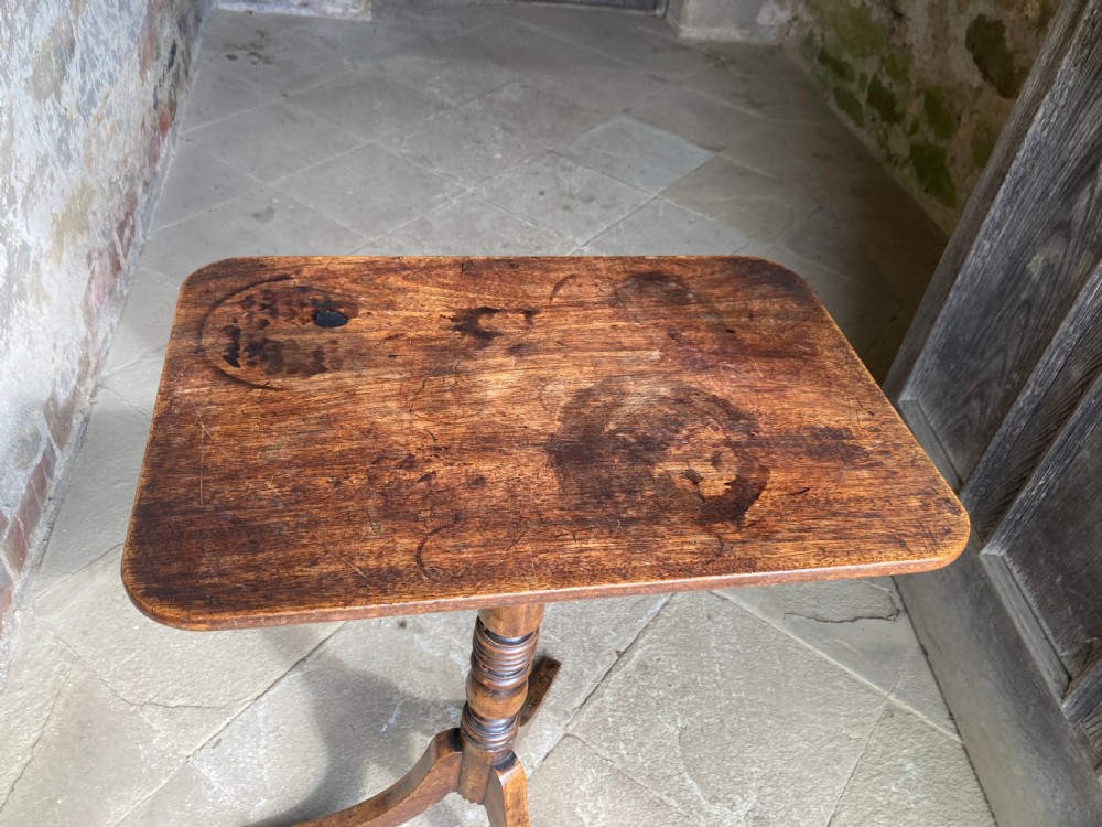 A Regency mahogany tripod table featuring a rectangular surface with rounded corners, a central turned stem, and three splayed legs. View VII
