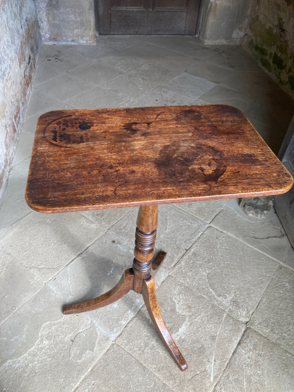 A Regency mahogany tripod table featuring a rectangular surface with rounded corners, a central turned stem, and three splayed legs. View VIII