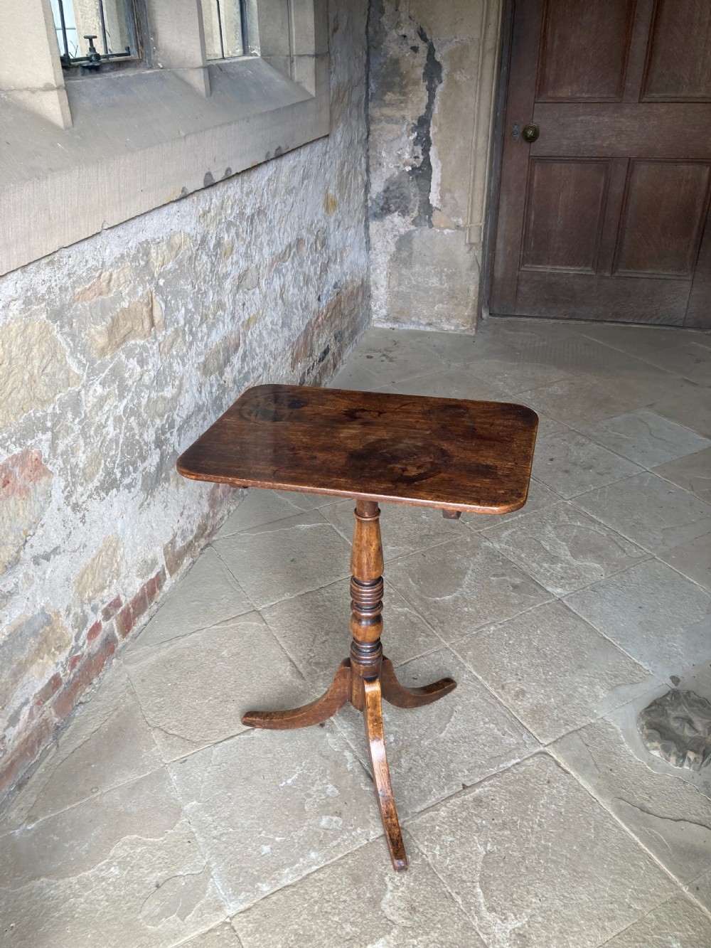 A Regency mahogany tripod table featuring a rectangular surface with rounded corners, a central turned stem, and three splayed legs. View X