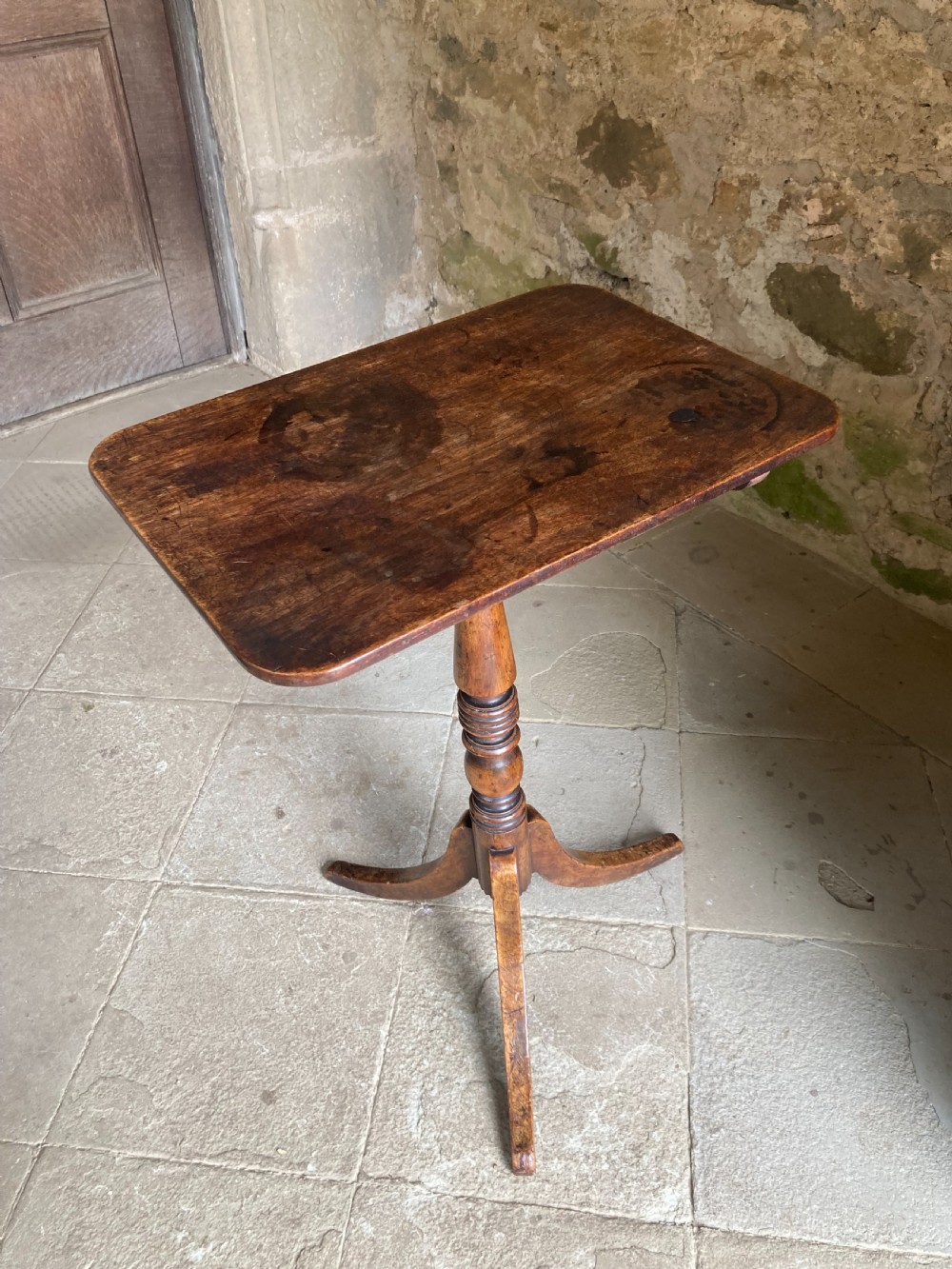 A Regency mahogany tripod table featuring a rectangular surface with rounded corners, a central turned stem, and three splayed legs. View XII