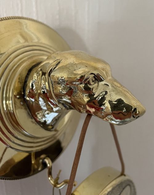 fig 5. WALL MOUNTED GONG HELD IN DOG’S MOUTH